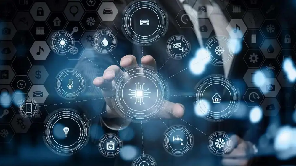 A hand reaching toward a glowing AI chip surrounded by circular icons for connected devices, sensors, security, finance and home systems.